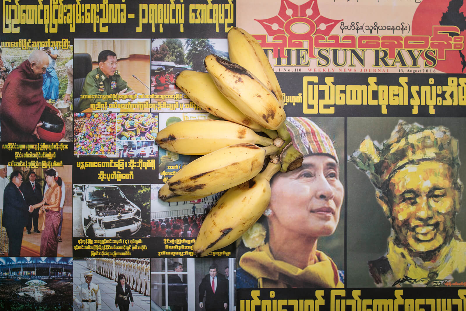 Lokalzeitung aus Myanmar von 2016, auf der Bananen liegen.